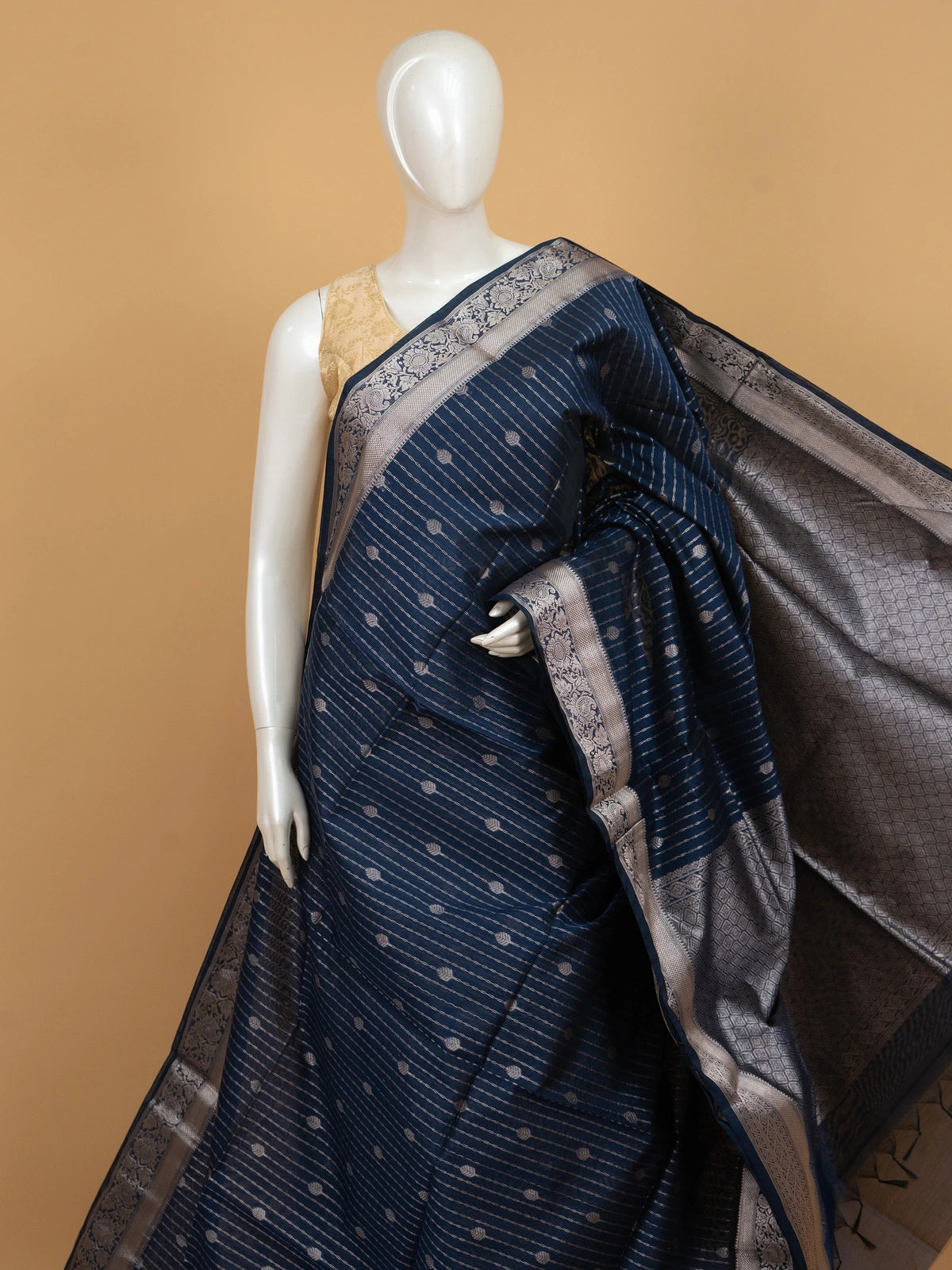 Navy blue silk cotton saree with silver zari stripes, buttis and ornate zari border