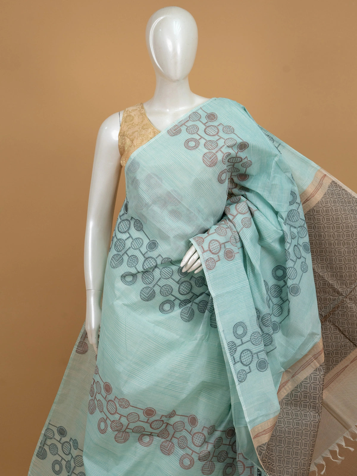 Aqua blue and grey silk cotton saree with circular motifs and copper zari border