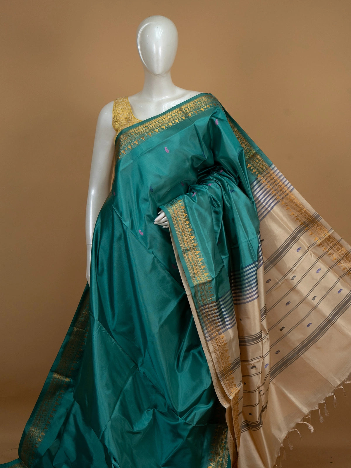 Teal green Banana Silk saree with gold zari border, paisley buttas and contrast cream pallu