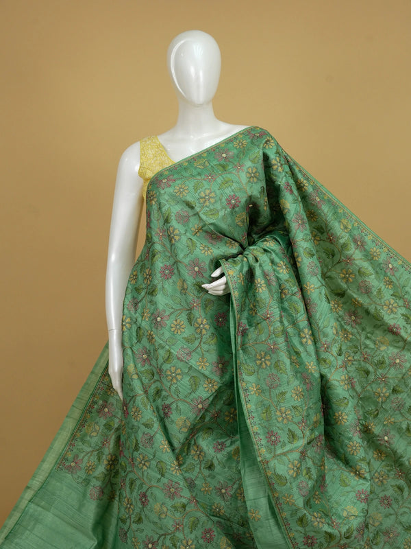 Green semi tussar saree with multicolour floral thread embroidery and gold zari accents