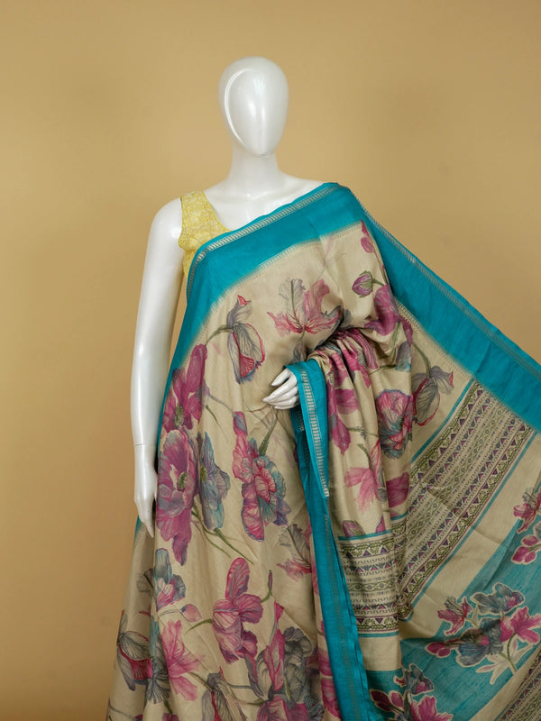 Beige Dola silk saree with pink and blue floral print and contrast teal zari border