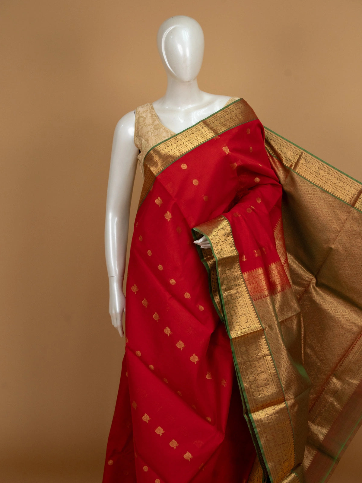Red pure silk cotton saree with gold zari border, temple pallu, and woven buttas