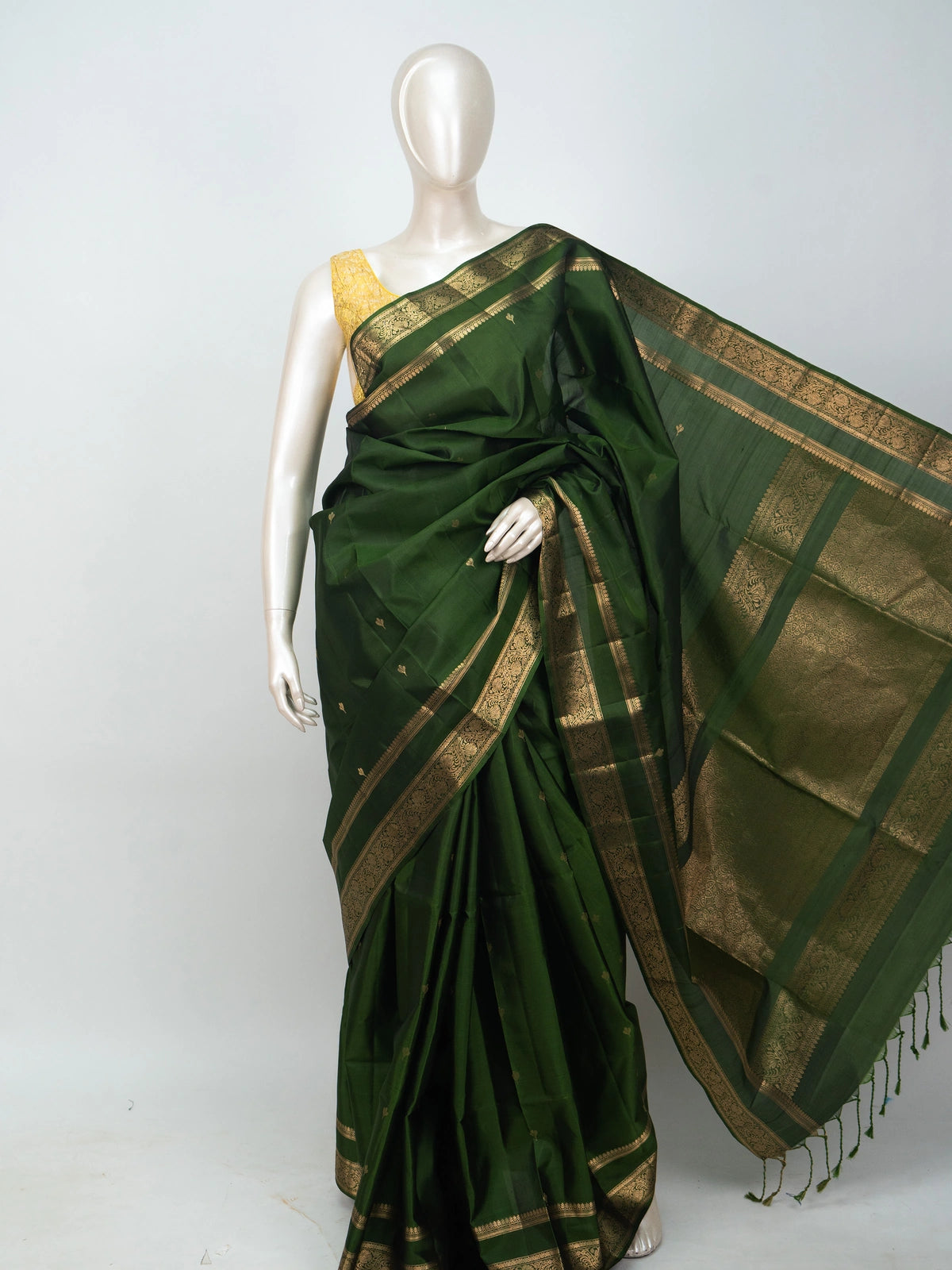 Dark green soft silk saree with gold zari floral border and buttis
