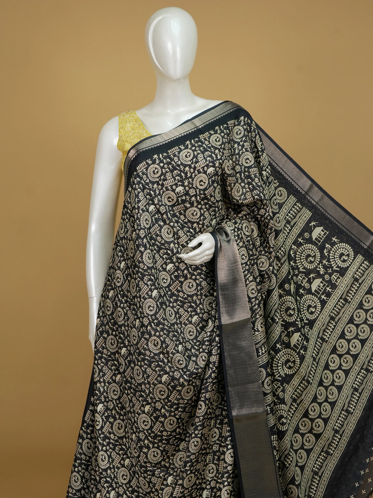 Black designer saree with cream Warli tribal art print and silver zari chevron border