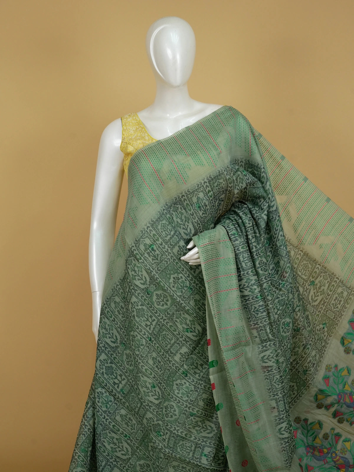 Sage green linen cotton saree with ikat-style motifs and Madhubani bird pallu
