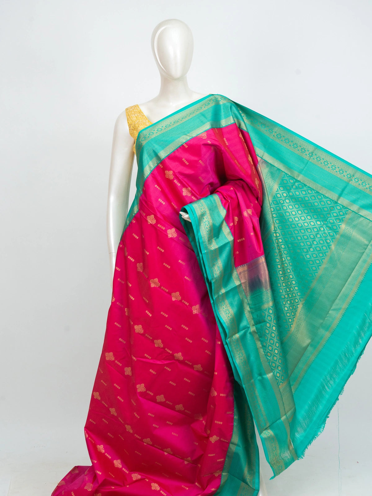 Rani pink Kanchipuram fancy silk saree with teal green contrast border, gold zari buttas and diamond-grid zari pallu