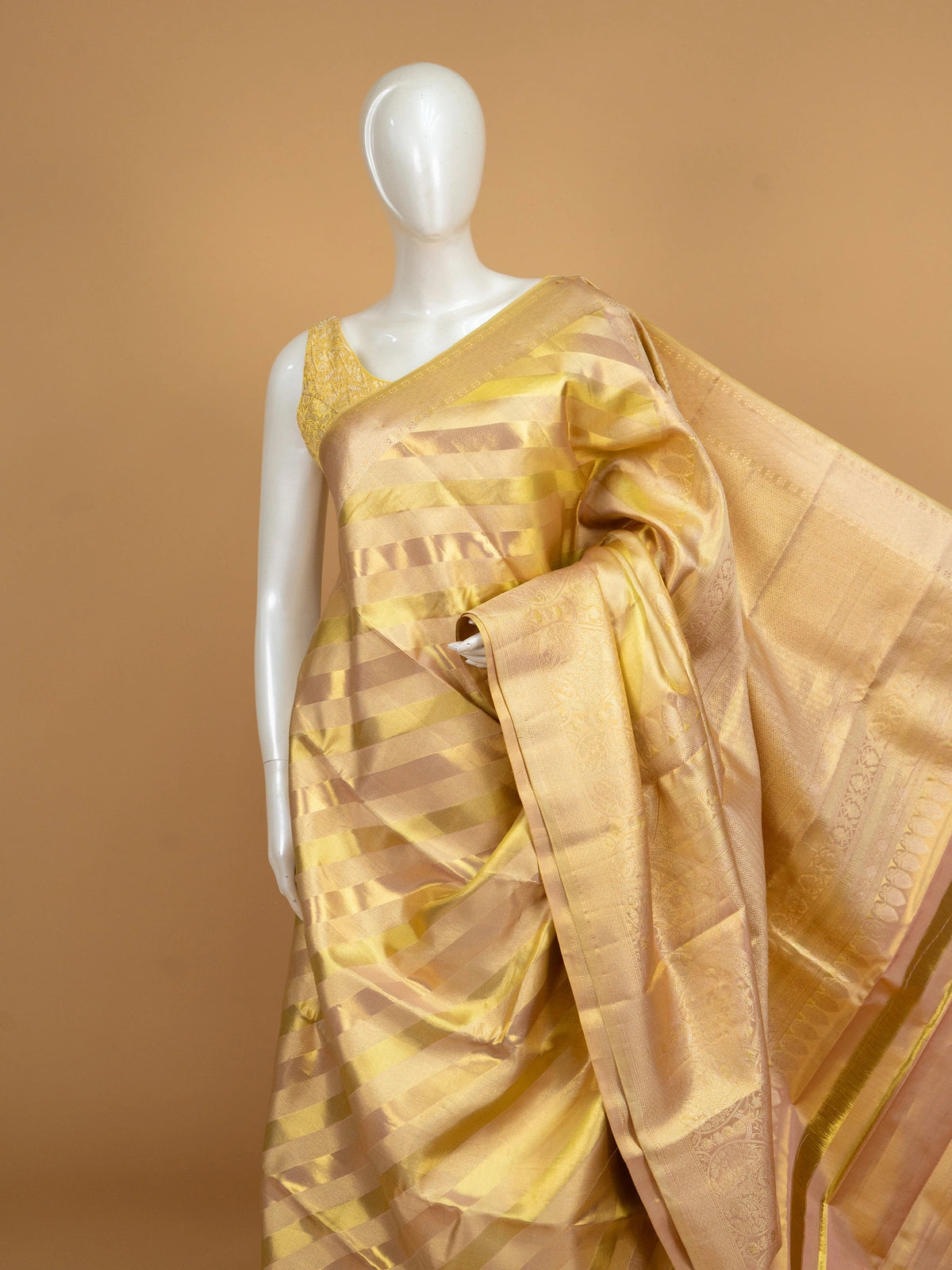 Gold and cream pure Kanchipuram silk saree with diagonal gold zari stripes and an ornate floral zari border