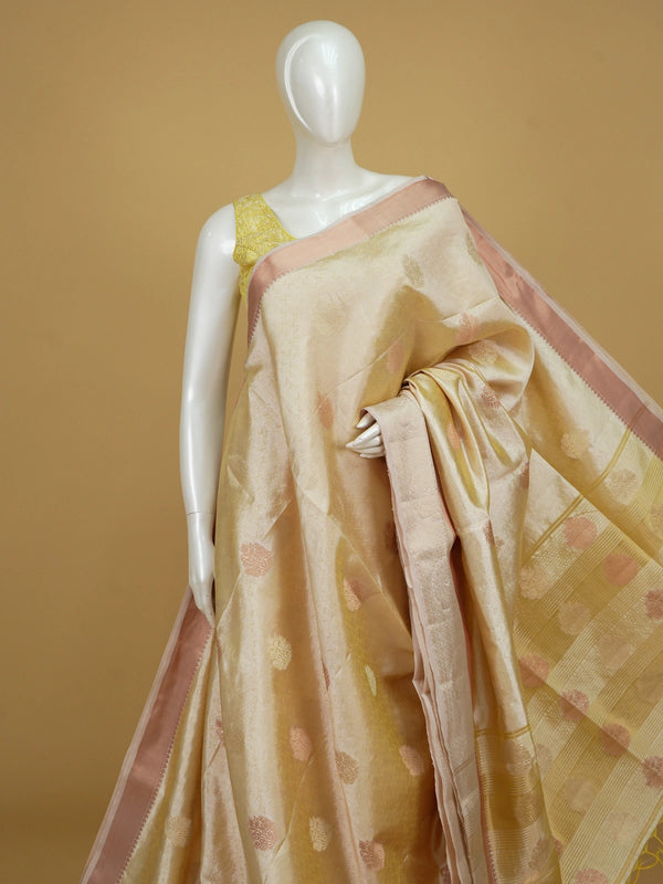 Cream gold semi tussar saree with woven floral zari buta and contrast peach border