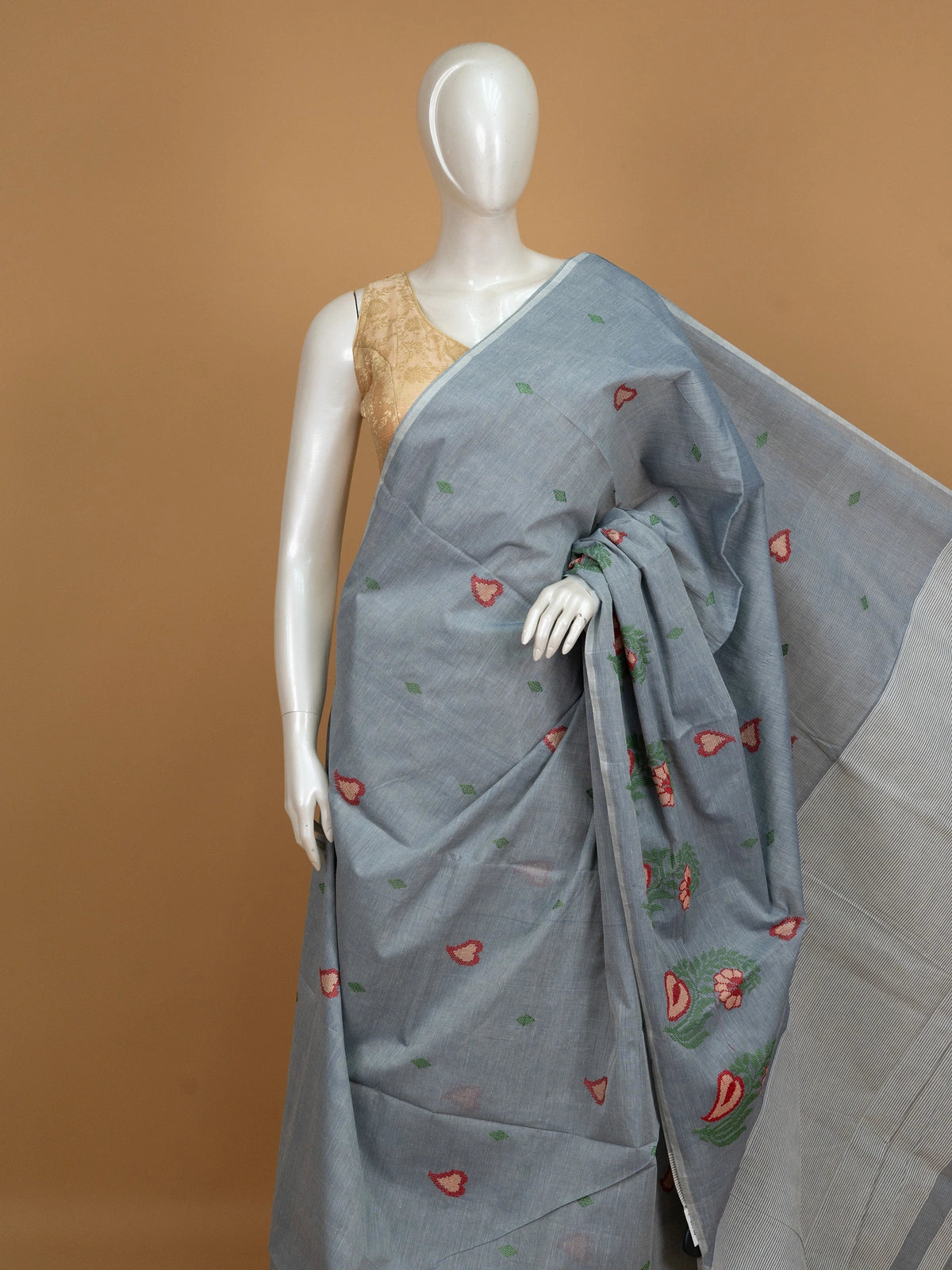 Grey linen cotton saree with red and cream floral buta motifs and striped pallu