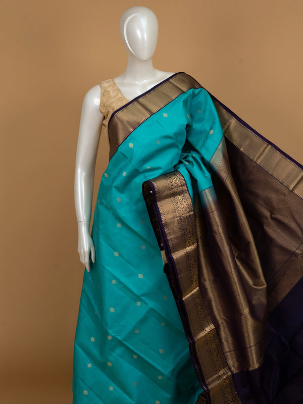 Teal Pure Kanchipuram silk saree with contrast purple and gold zari border and pallu