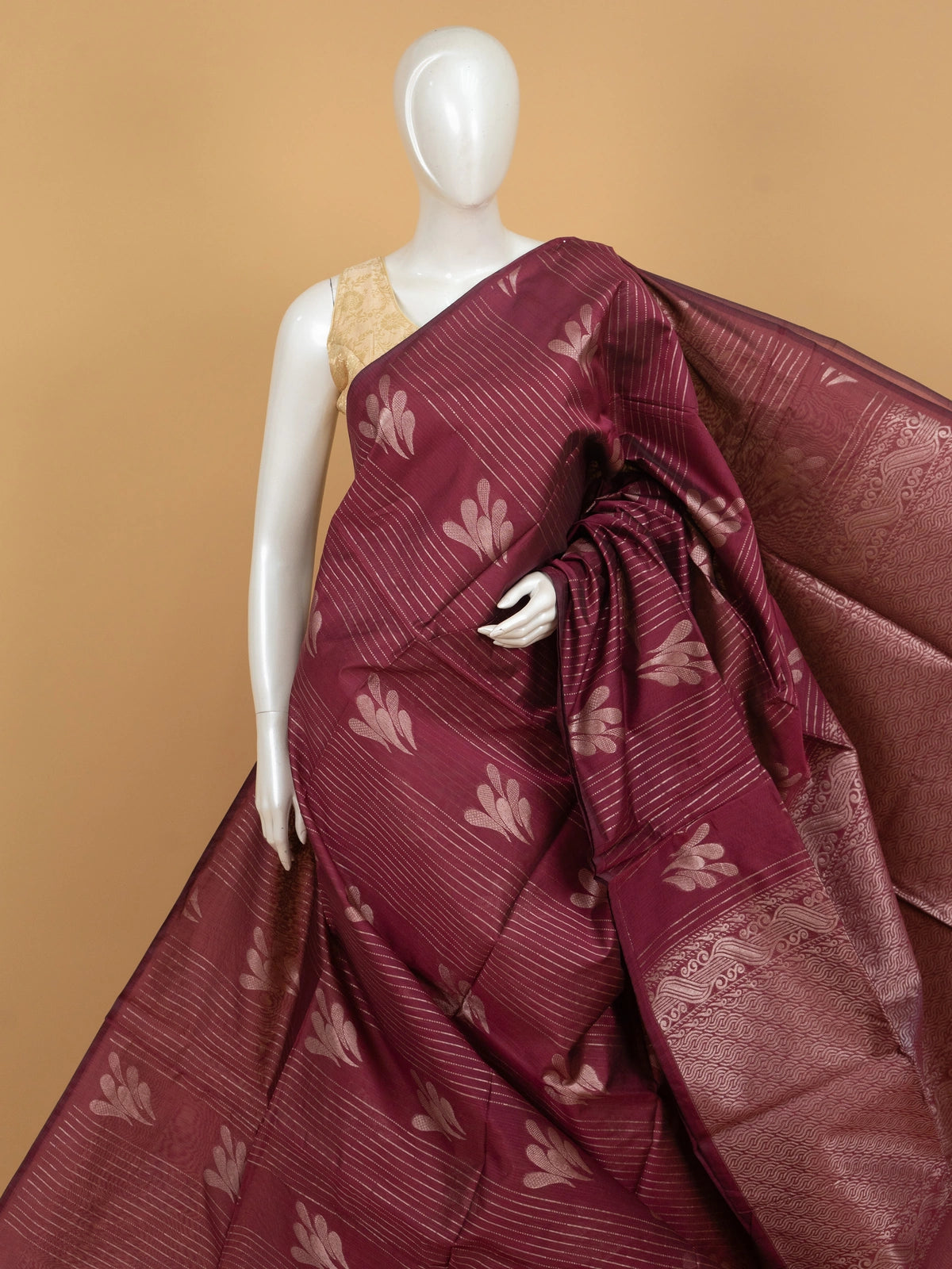 Maroon silk cotton saree with silver zari stripes, leaf motifs and woven scroll border