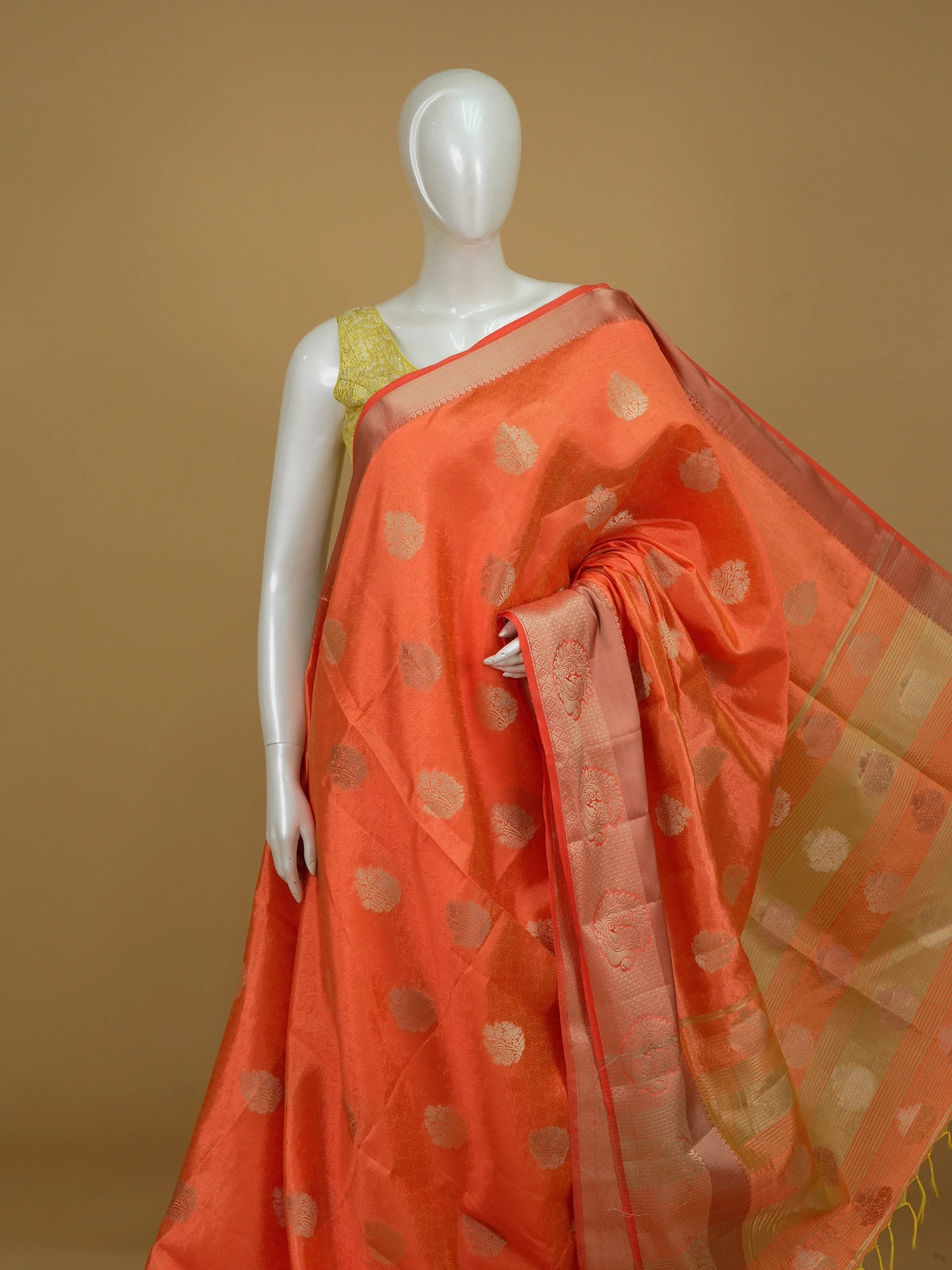 Orange semi tussar saree with gold zari floral buttas and ornate contrast zari border
