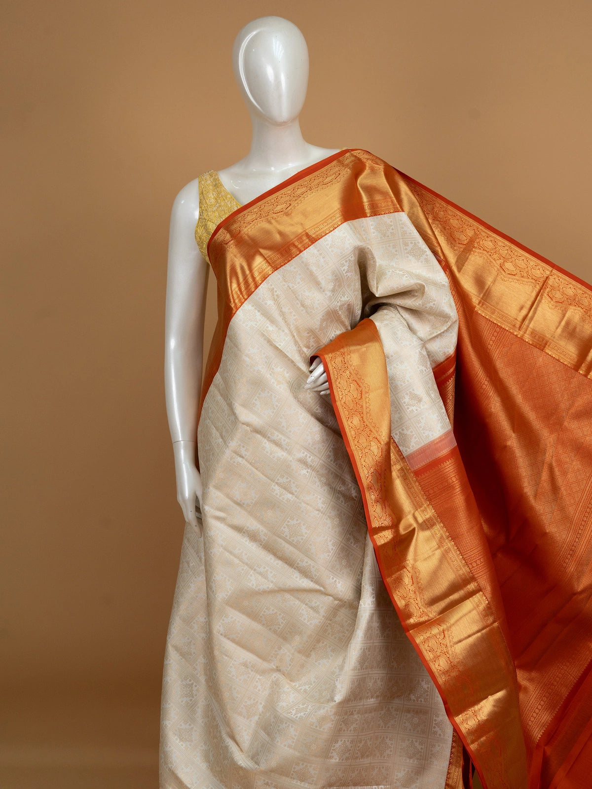 Cream Pure Kanchipuram silk saree with gold zari checkerboard body and contrast orange zari border