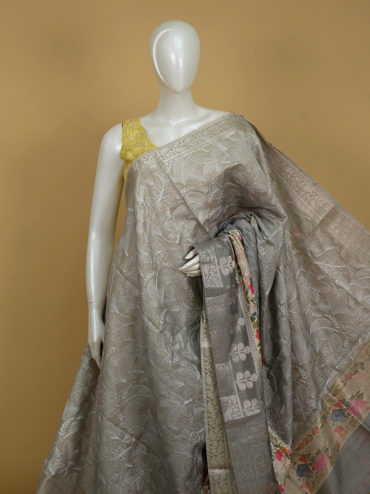 Grey designer saree with white floral embroidery, silver zari border and multicoloured embroidered roses