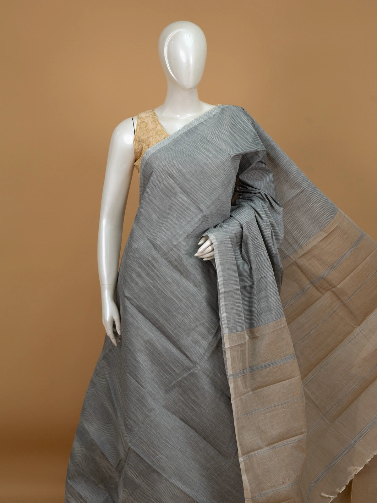 Grey silk cotton saree with striped texture, contrast beige border, and striped beige pallu