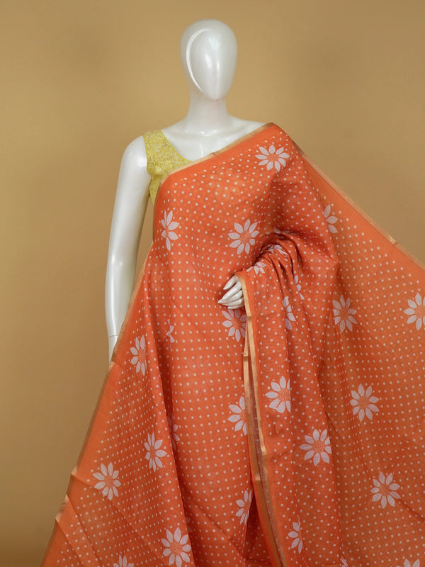 Orange linen cotton saree with white polka dots, floral motifs and a thin gold border