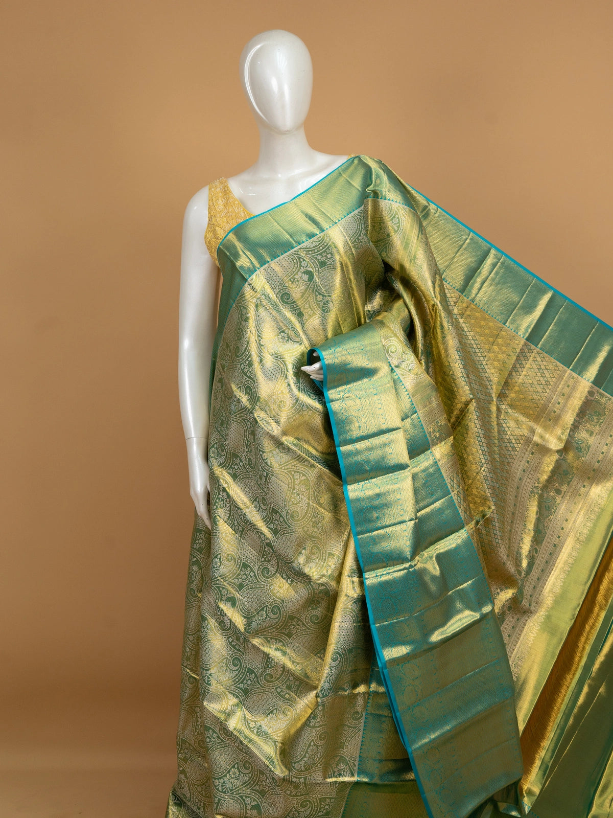 Green pure Kanchipuram silk saree with gold zari brocade body and contrast teal blue zari border
