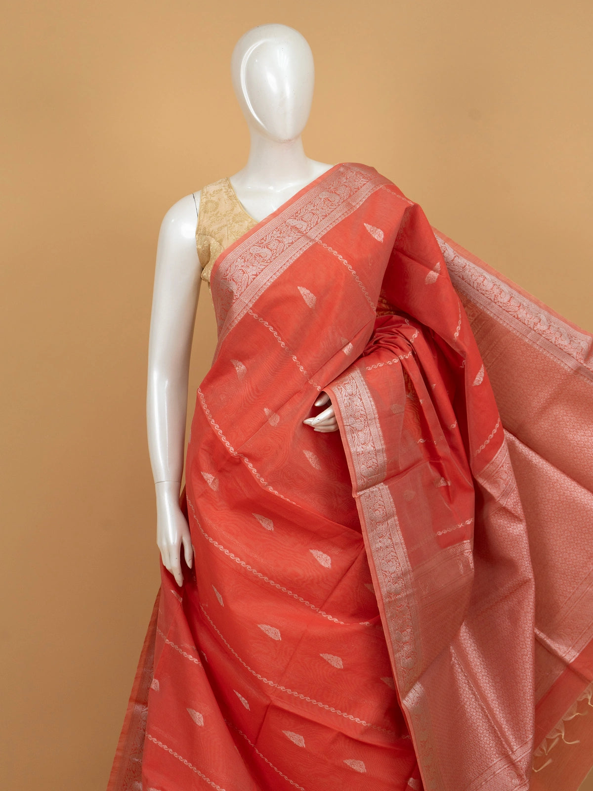 Coral orange silk cotton saree with silver zari buttis and ornate zari border