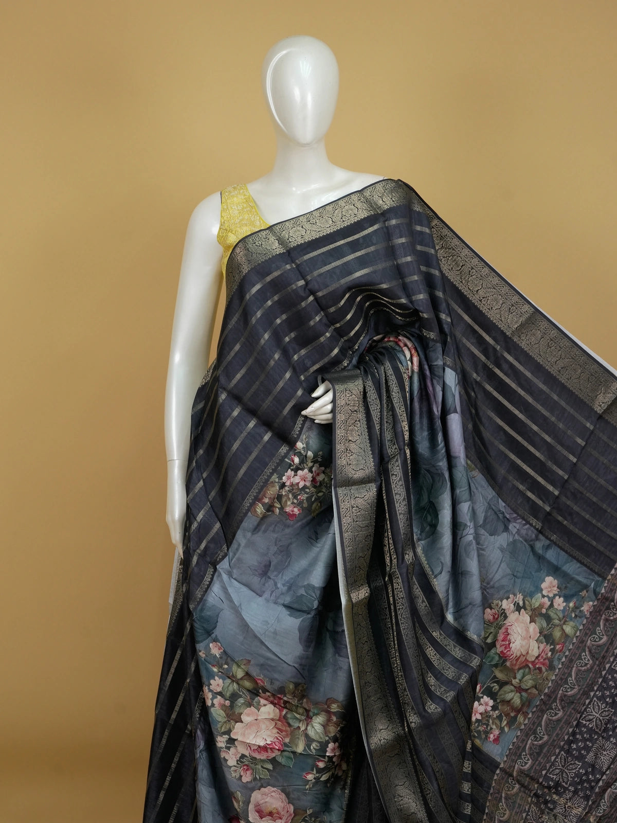 Charcoal grey semi tussar saree with gold zari stripes, floral prints, and a woven gold border