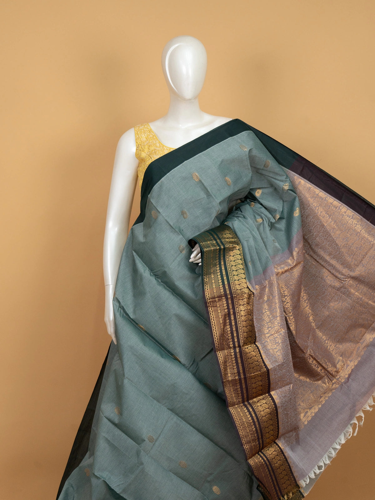 Sage green Chettinad cotton saree with teal gold zari contrast border and paisley buttas
