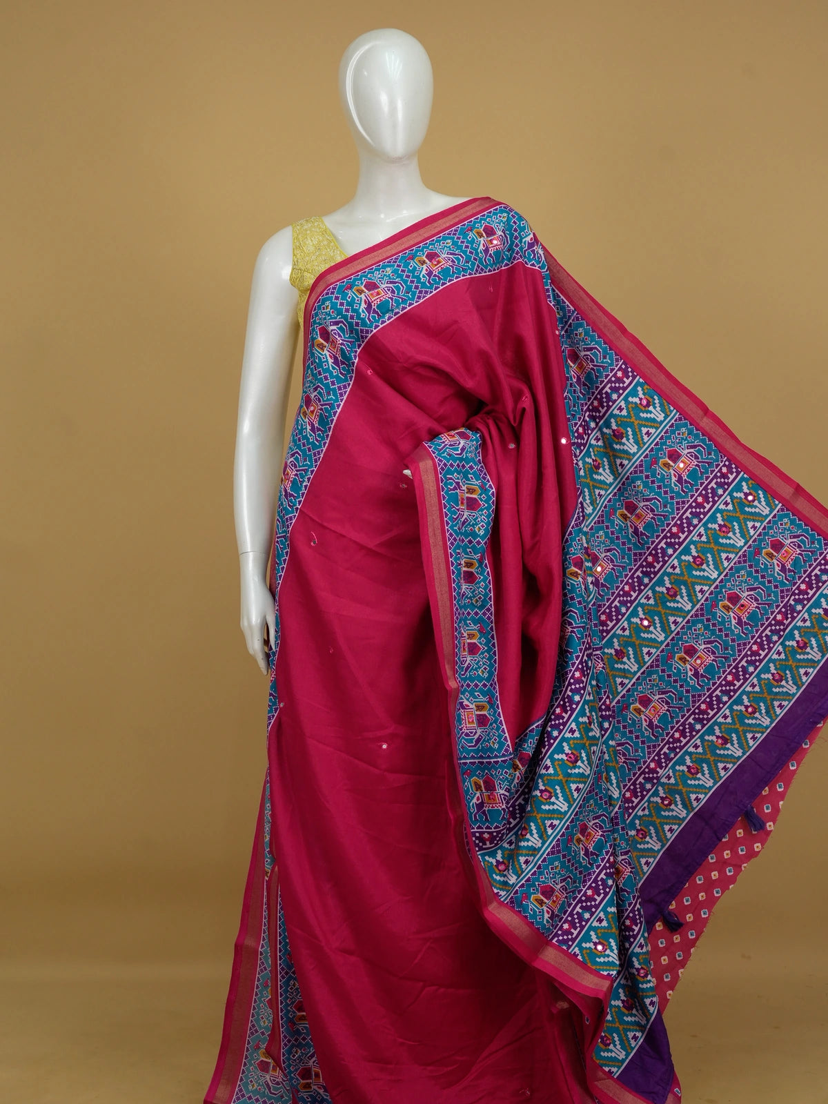 Rani pink linen cotton saree with teal and purple patola elephant border and mirror-work body