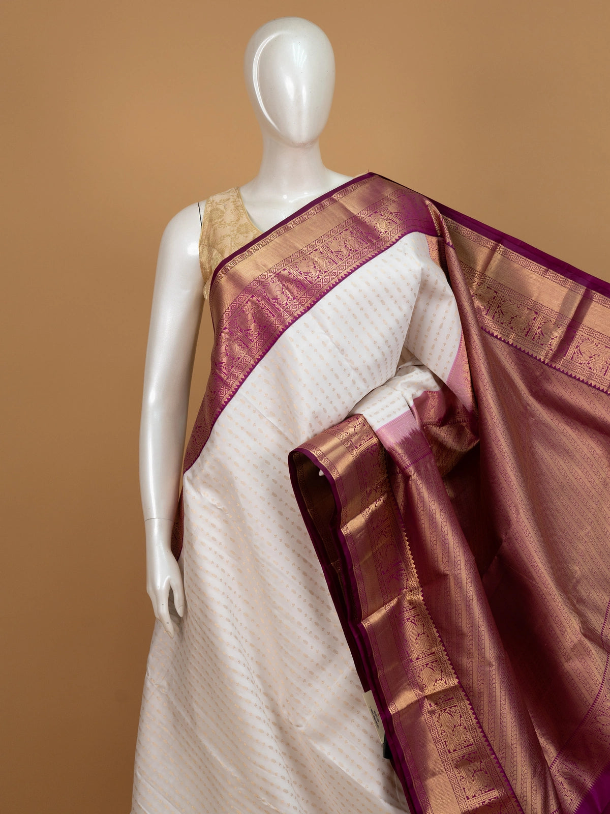 Cream pure Kanchipuram silk saree with gold zari buttis and contrast magenta zari border