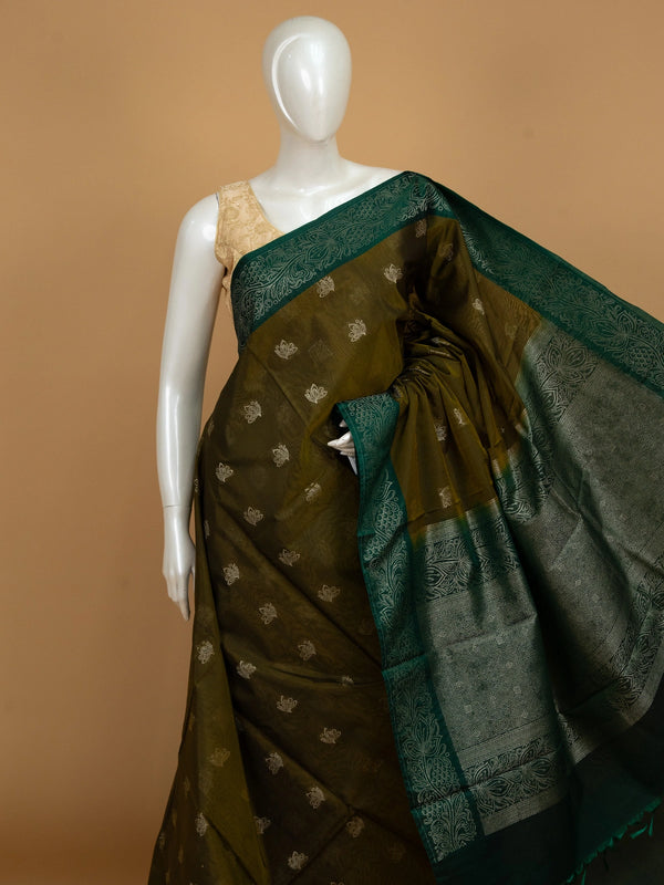 Mehendi green silk cotton saree with contrast bottle green zari border and silver lotus buttas