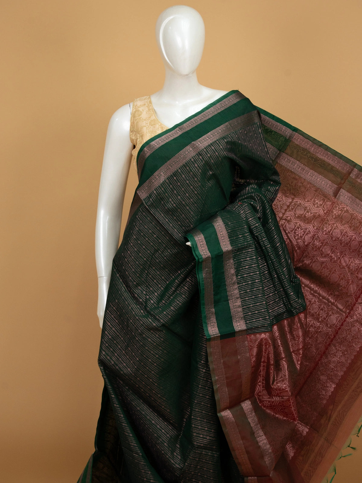 Dark green silk cotton saree with contrast maroon zari border and woven pallu