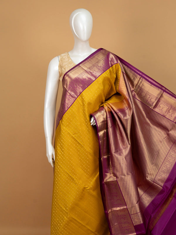 Mustard yellow pure Kanchipuram silk saree with magenta contrast gold zari border and pallu