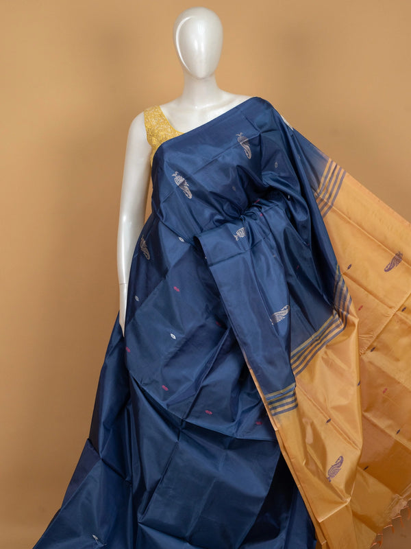 Navy blue banana silk saree with mustard contrast pallu and silver zari peacock buttas