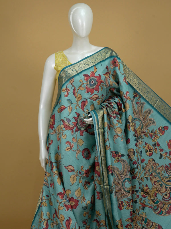 Teal blue semi tussar saree with Kalamkari floral and peacock print and gold zari border