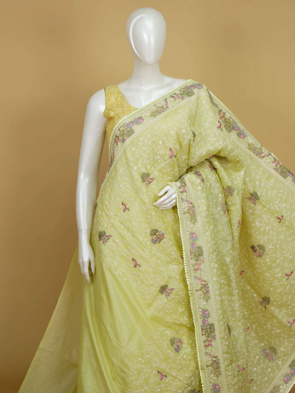 Lime green designer saree with white floral jaal, pink bird, tree and elephant embroidery and matching blouse