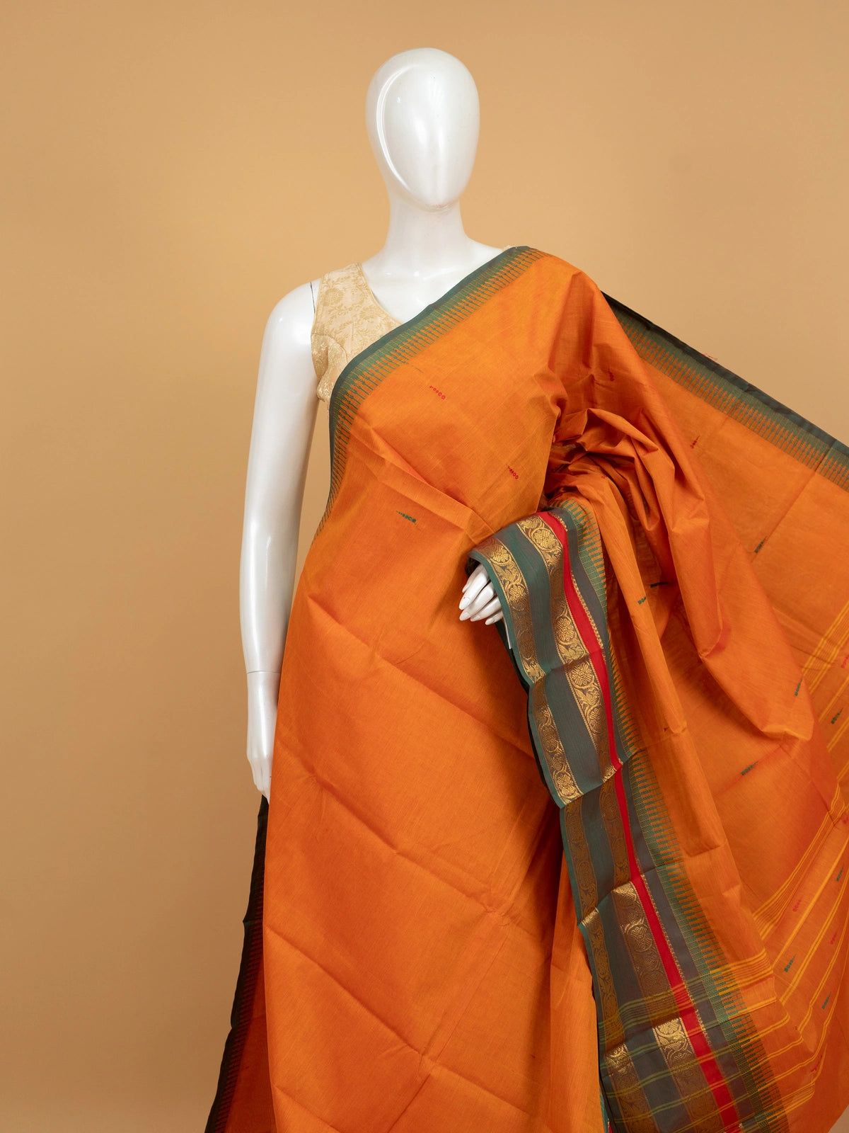 Orange Chettinad cotton saree with contrast green and gold zari border and woven buttas