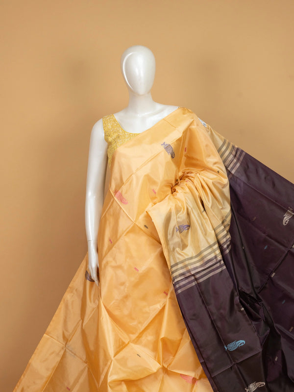 Golden yellow banana silk saree with plum contrast pallu, zari stripes and paisley buttas