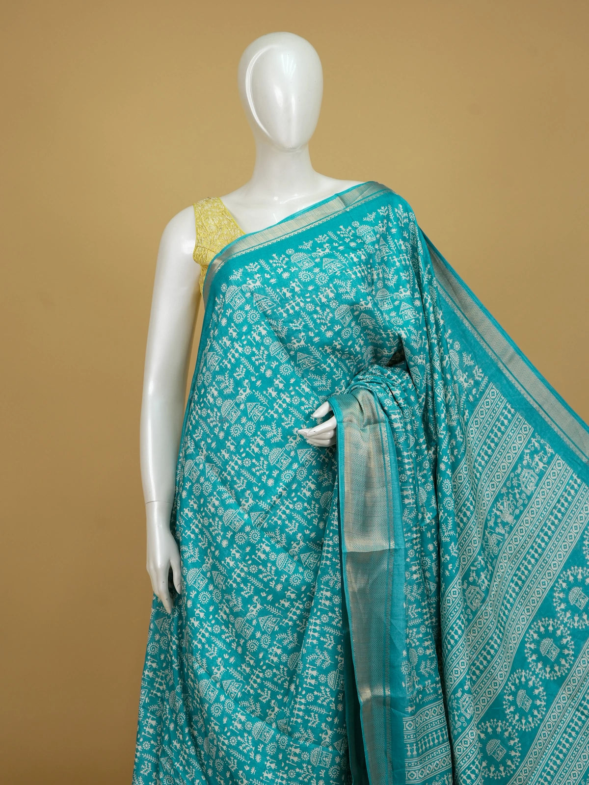 Teal blue designer saree with white Warli tribal print and gold zari border