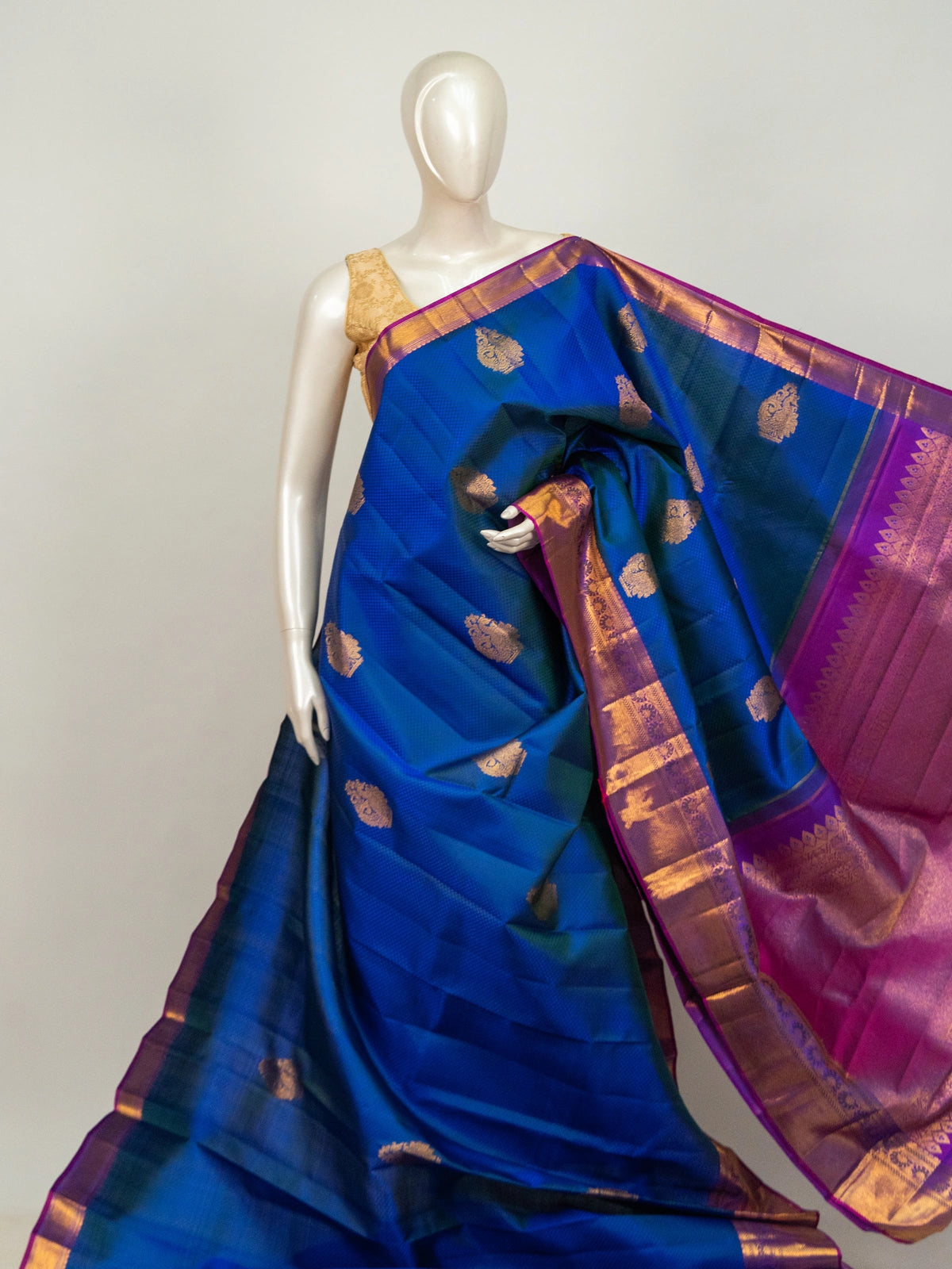 Royal blue Pure Kanchipuram silk saree with contrast magenta border, gold zari buttas and woven pallu