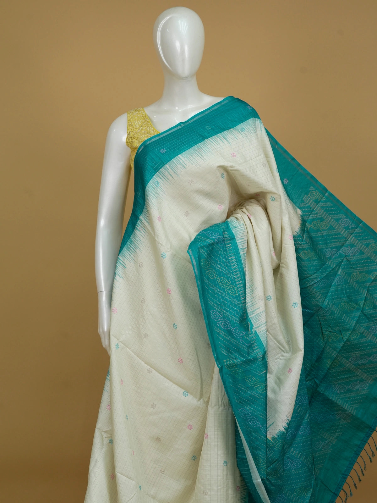 Cream and teal Dola silk saree with contrast temple border, floral buttas and patterned pallu