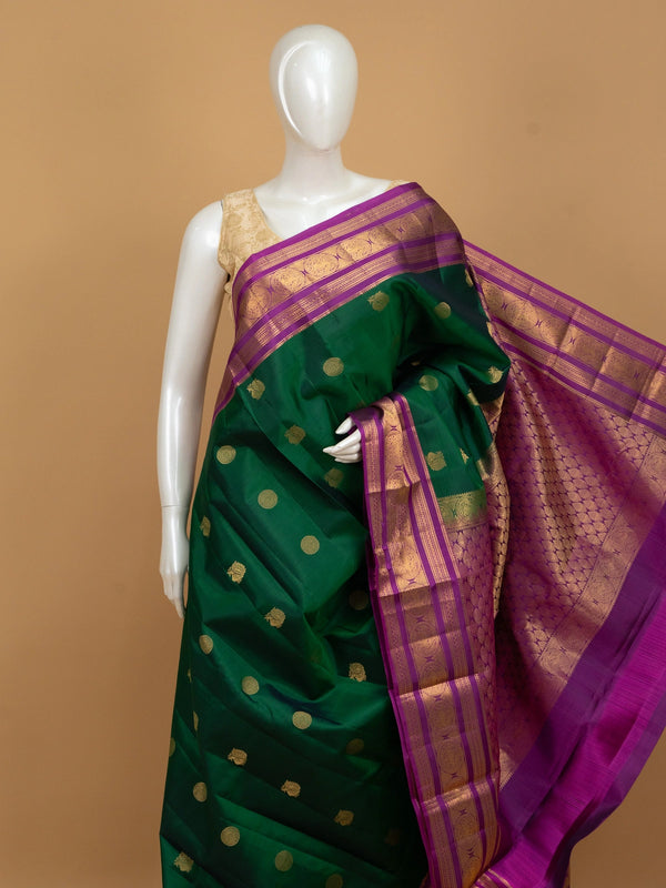 Green pure Kanchipuram silk saree with contrast magenta gold zari border and buttas