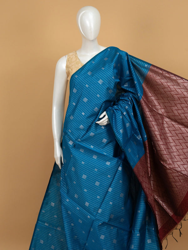 Peacock blue silk cotton saree with silver stripes, square buttas and contrast maroon zari border and pallu