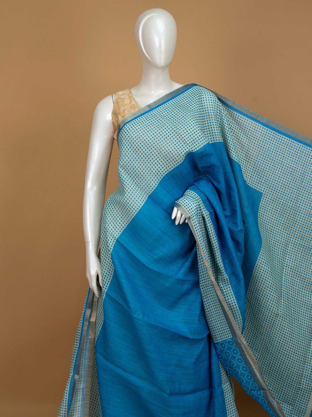 Peacock blue linen cotton saree with cream checked body, silver zari border and printed pallu