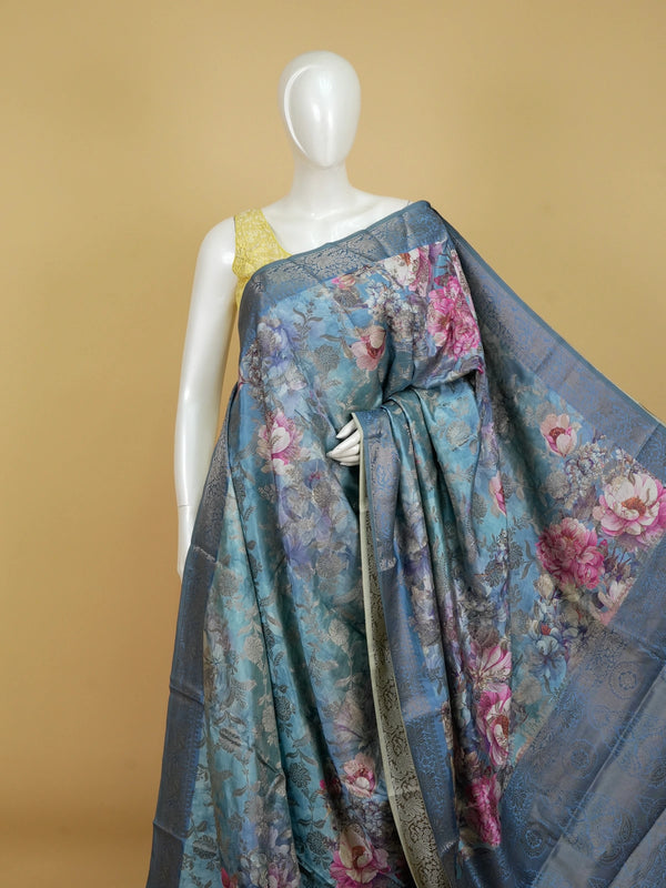 Teal blue semi tussar saree with pink floral print and contrast zari border