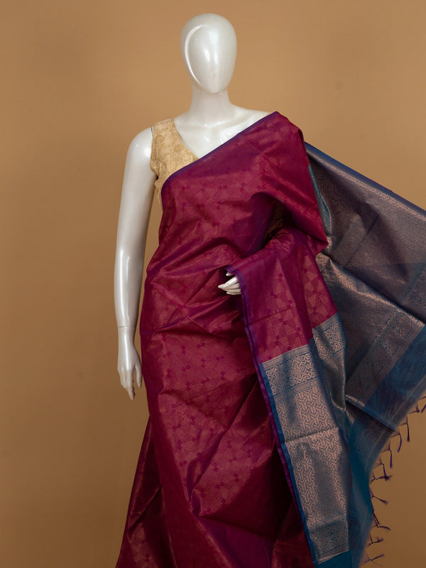 Magenta silk cotton saree with gold zari stripes and contrast blue zari border and pallu