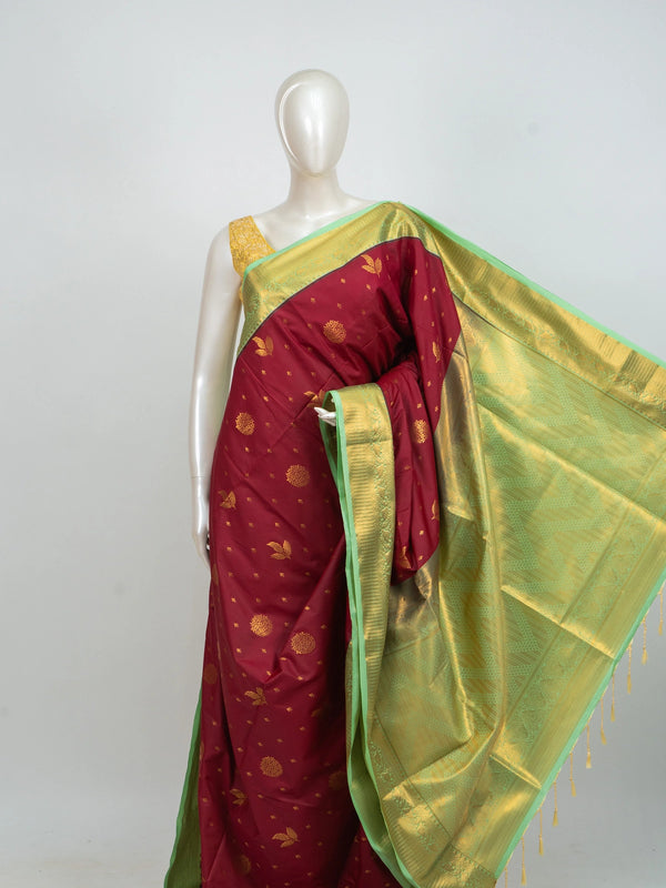 Maroon Kanchipuram fancy silk saree with contrast green and gold zari border and floral zari buttis