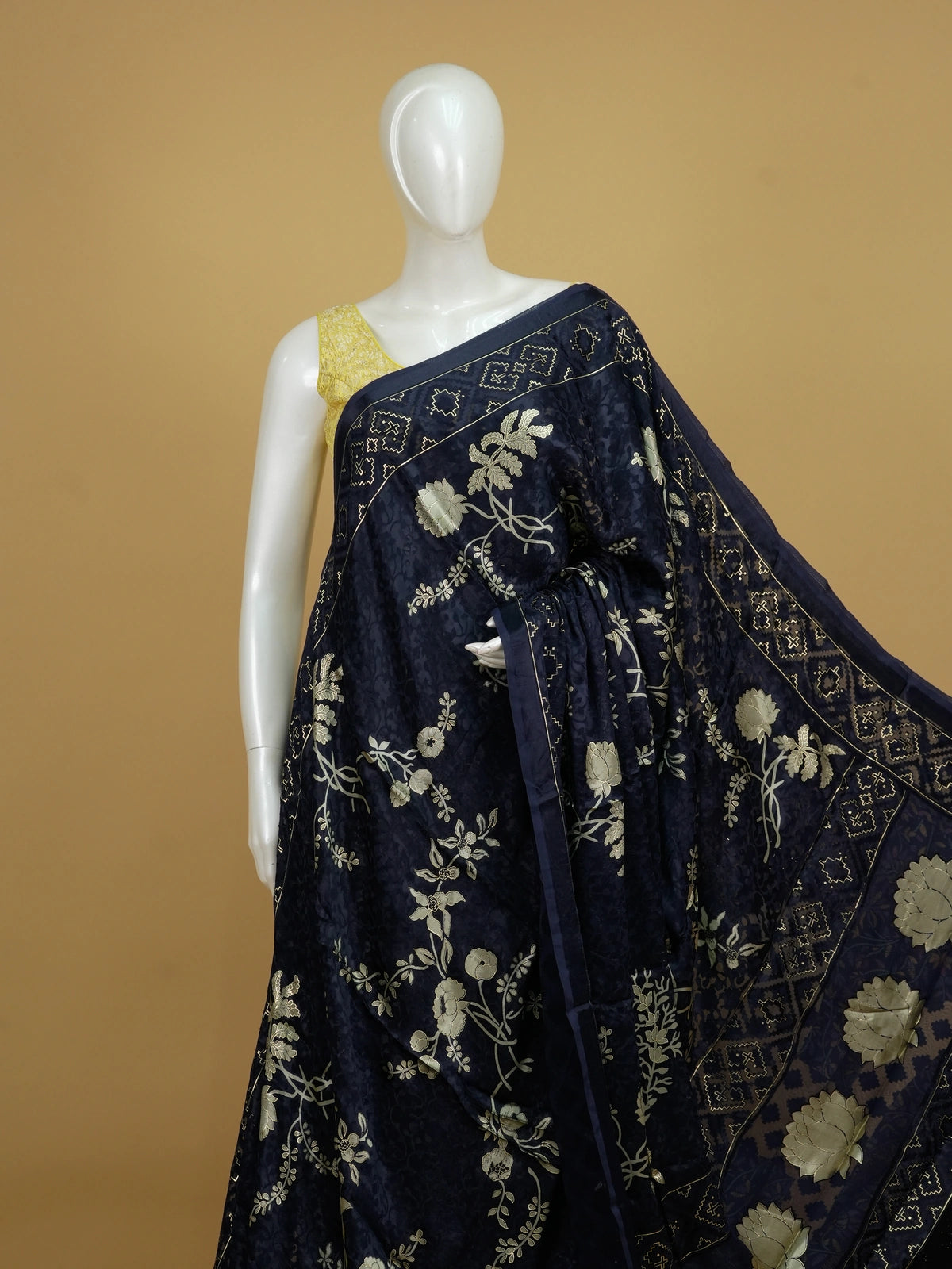 Navy blue designer saree with gold floral print, lotus pallu motifs and patola geometric border