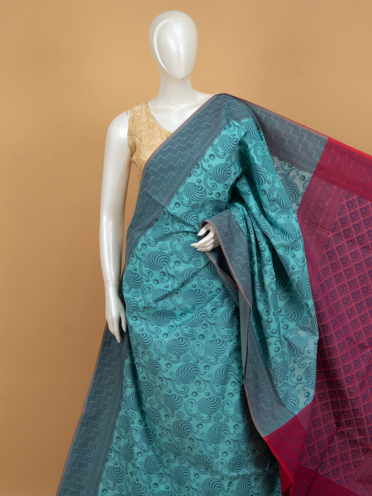 Teal blue silk cotton saree with woven swirl motifs and contrast magenta pink border and pallu