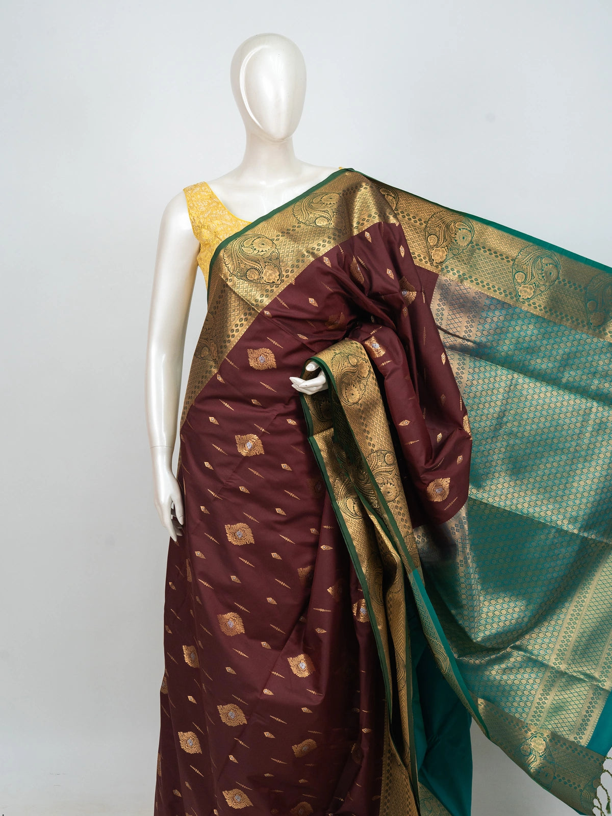 Maroon semi silk saree with gold zari buttas and a contrast teal zari border and pallu