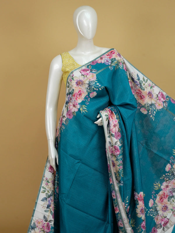 Teal blue semi tussar saree with ivory floral border and silver zari striping