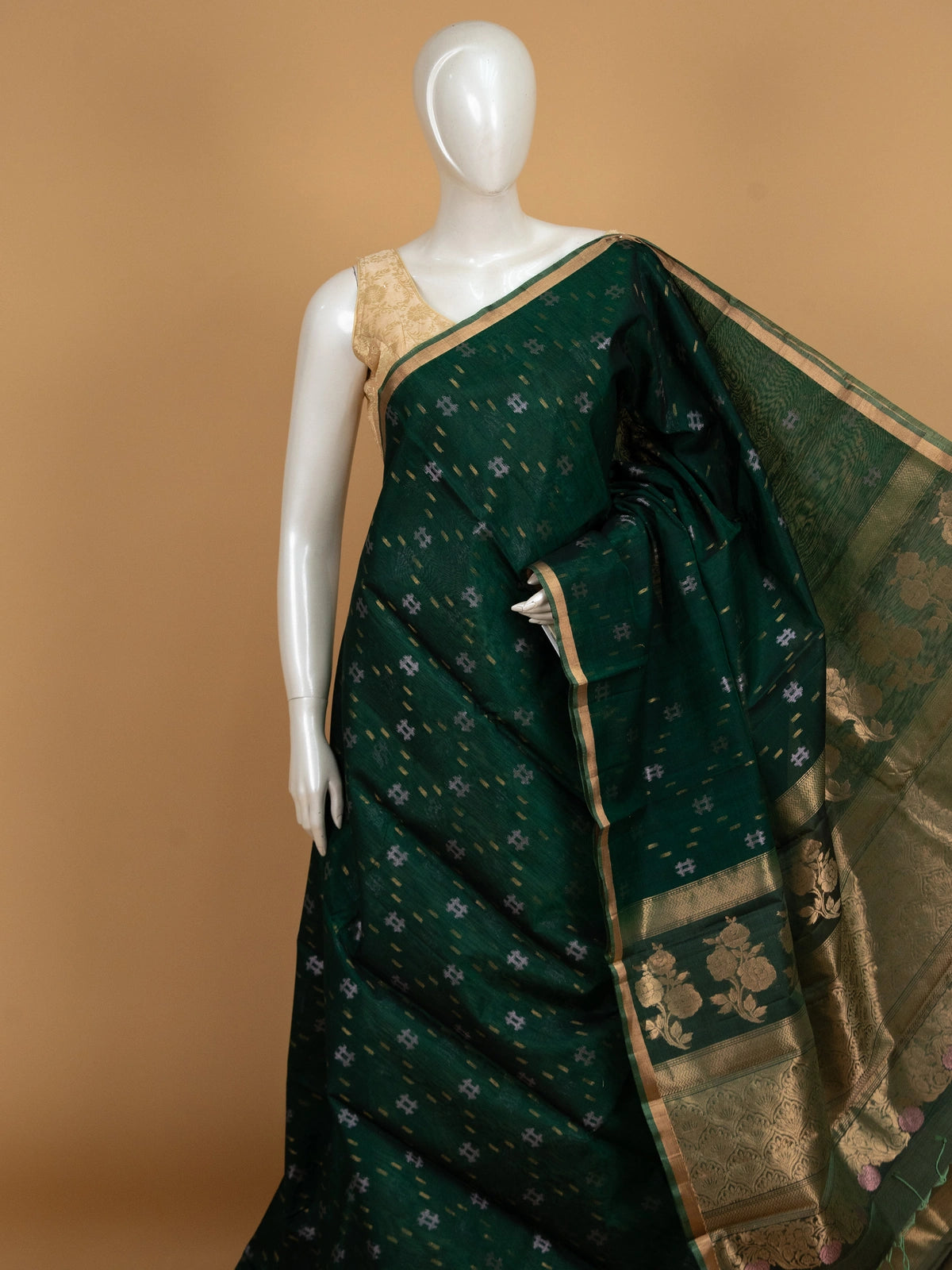 Dark green pure silk cotton saree with gold zari floral border and ikat-style buttas