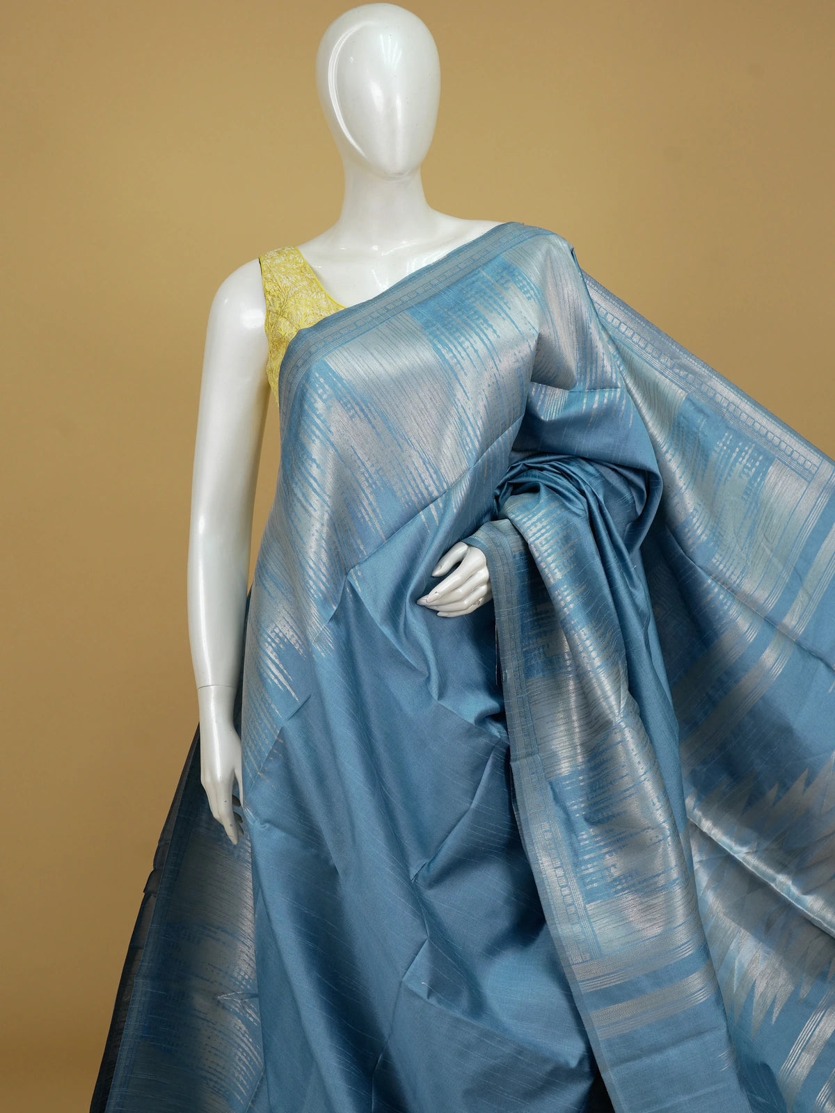 Blue semi tussar saree with silver zari vertical streaks, woven zari border and temple-motif pallu