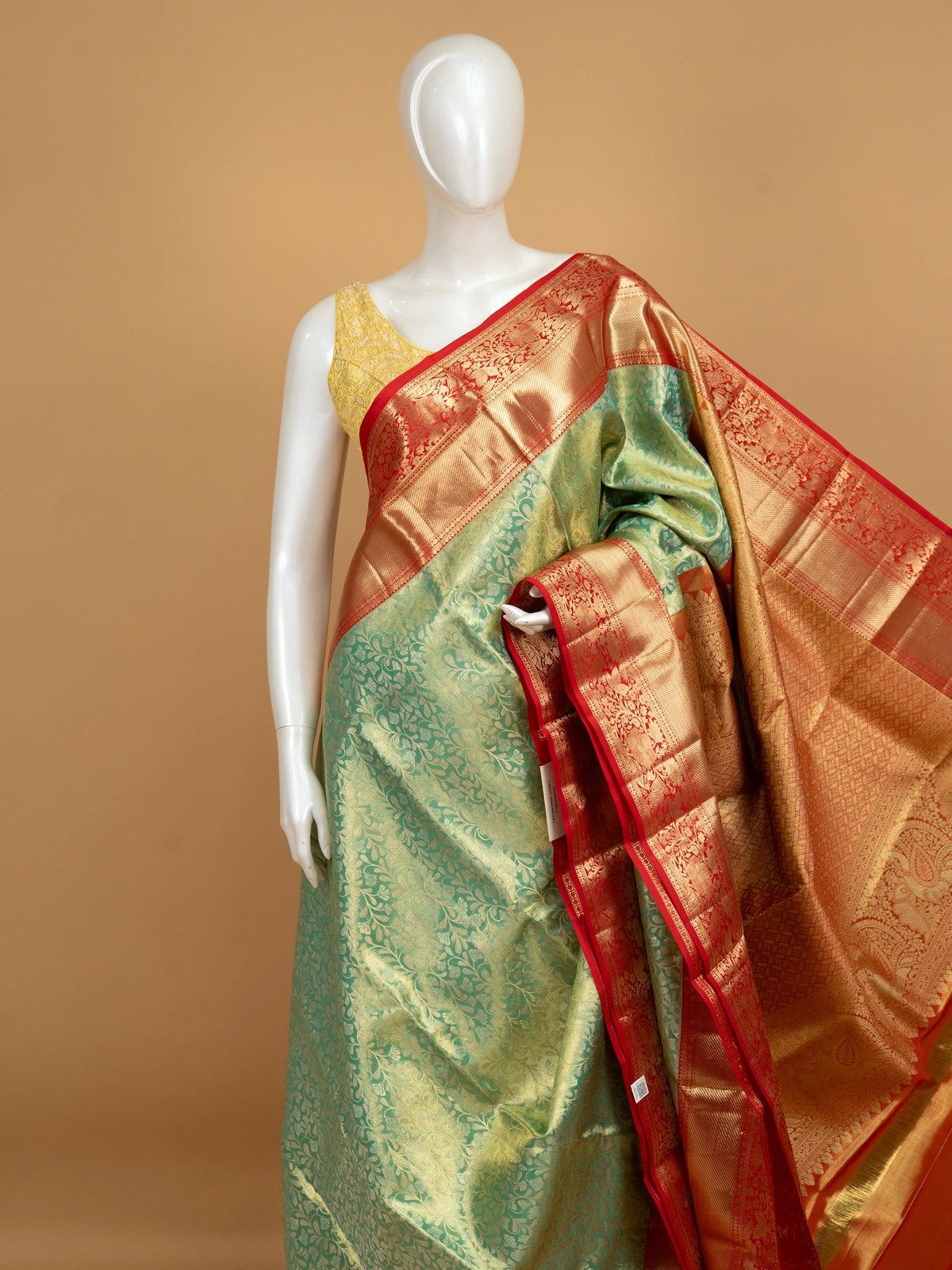 Green pure Kanchipuram silk saree with contrast red border and gold zari floral weaving